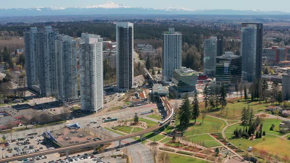 Aerial Zoom In on a Skytrain in Motion at King George Station, Surrey BC Canada. Fast Drone View fro alt