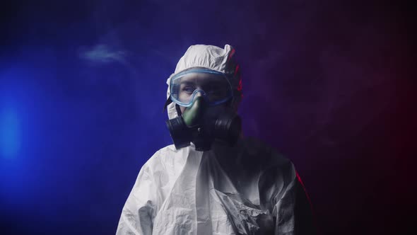 A Woman in White Protective Medicine Suit in Smoky Room alt