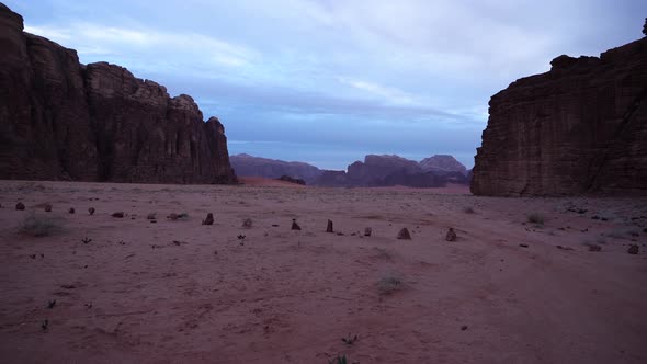 Wadi Rum Desert Early in the Morning With Clouds and Mountains Visible in the Background  alt