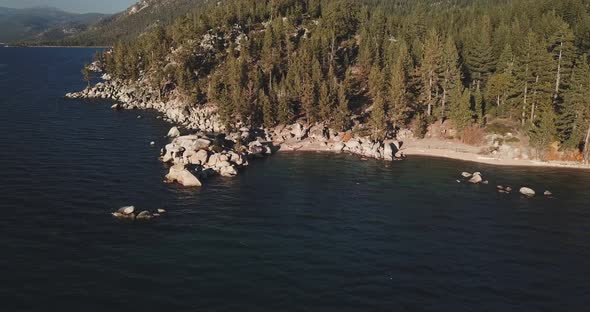 Flying Around A Rocky Beach At Lake Tahoe