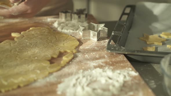 Putting Raw Christmas Cookies From Counter to Backing Sheet alt