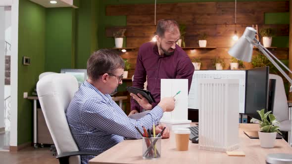 Team of Architects in the Office Having a Conversation alt