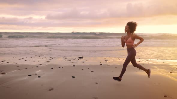 Somali woman jogging on the beach in Malibu alt