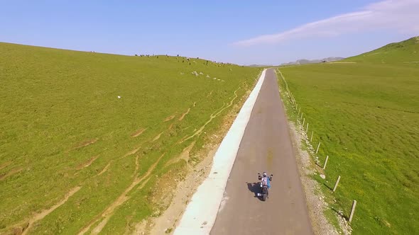 Motorcyclist driving his motorbike on the mountain road in the country side. alt
