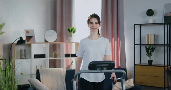 Brunette Posing on Camera when Training on Running Track on Beautifully Decorated Home interier alt