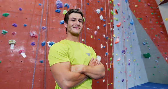 Confident man standing with arms crossed in fitness studio 4k alt