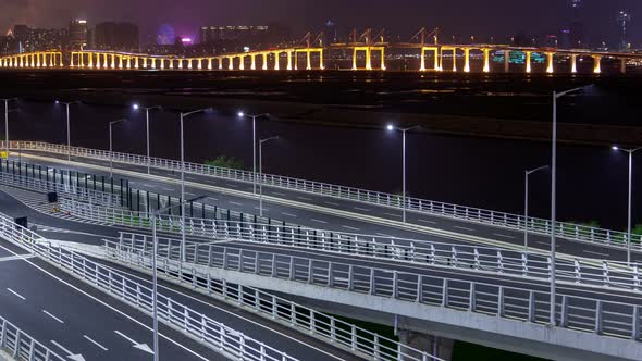 Macau Bridge Traffic Cityscape Night Timelapse Pan Up alt