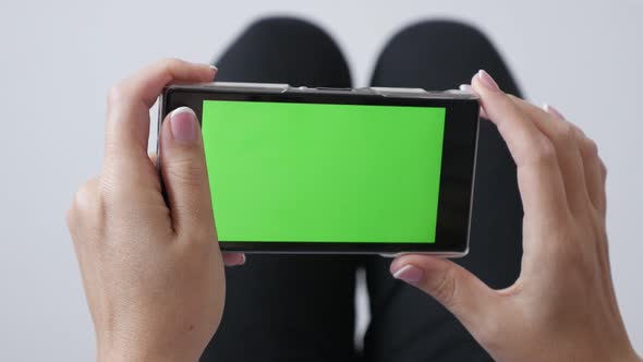 Woman holding in hands  chroma key greenscreen smart phone  4K 2160p 30fps UltraHD footage - Relaxed
