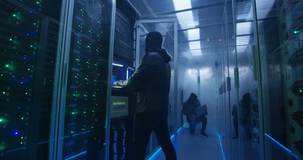 Two Hackers Finishing Hack and Escaping a Smoke-filled Room alt