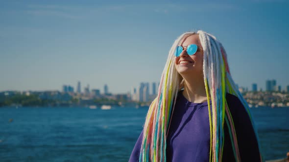 Young Hipster Woman Walking Along Embankment Against Istanbul and Bosphorus alt