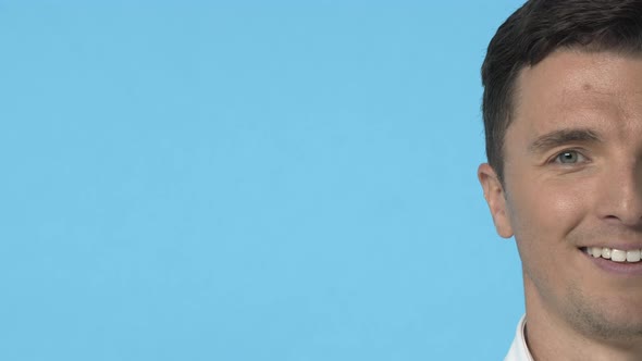 Slowmotion Closeup Portrait Half Face of Handsome Young Caucasian Guy with Beaming Smile Looking alt