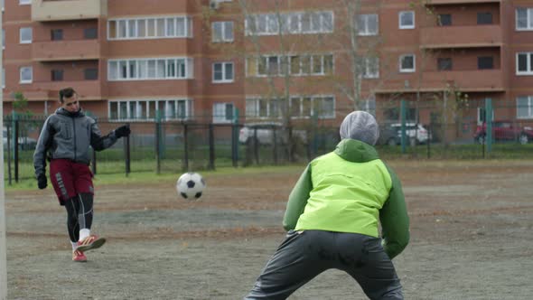 Goalkeeper Parrying Soccer Ball while Training with Partner on Outdoor Field alt