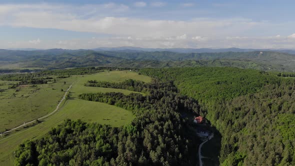 Aerial View To Beautiful Green Lawns in the Mountains on a Sunny Day. Flight Over the Carpathians alt