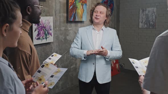 Art Gallery Owner Talking to Visitors alt