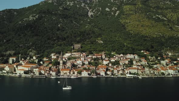 Aerial view of city Perast in Montenegro. Flying over the Kotor Bay and mountains alt
