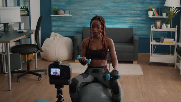 Black Woman Trainer Practicing Morning Yoga Exercise Sitting on Fitness Swiss Ball alt
