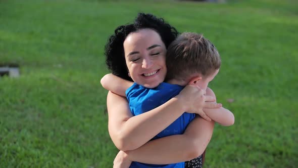 Happy Family Concept. Cute Affectionate Son Adopted Little Child Baby Boy Hugs Parent's Mother alt