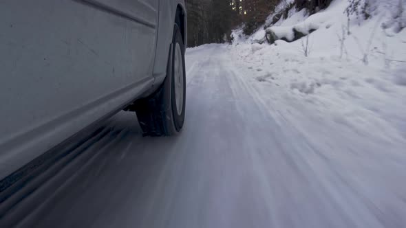 Car Wheel While On Snow Road alt