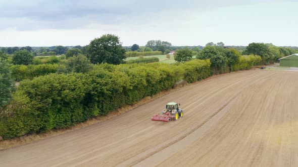 Aerial view of an agriculture field with tractor alt