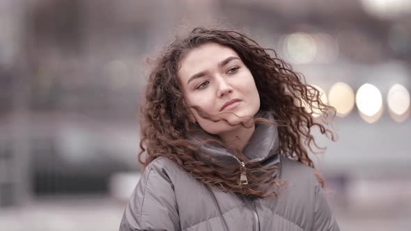 Sad and Pensive Young Lady Is Walking in City Portrait of Townswoman at Autumn or Winter alt