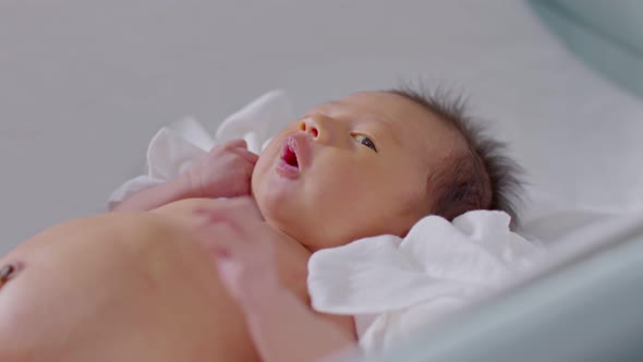 Happiness Newborn baby lying on baby bed after bathing alt