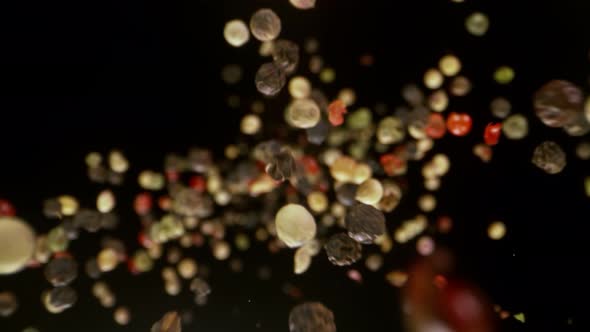 Super Slow Motion Detail Shot of Color Pepper Flying Towards Camera at 1000Fps alt