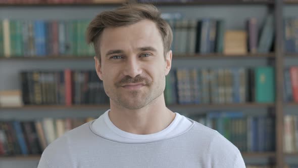 Portrait of Smiling Adult Man Looking at Camera alt