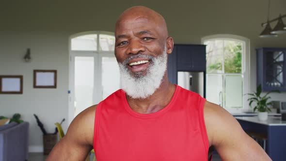 Portrait of african american senior man smiling at home alt