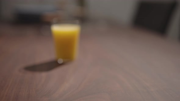 Slow Motion Man Put Pesto Fettuccine with Mozzarella in Blue Bowl on Walnut Table alt
