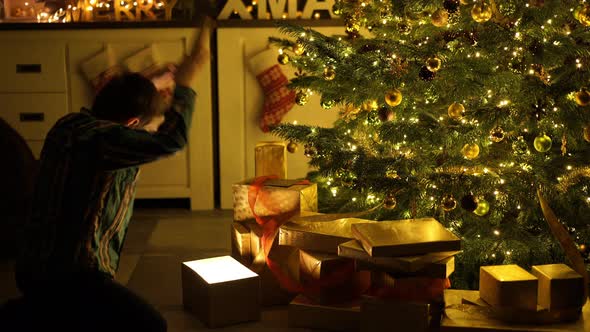 Boy Opening Christmas Present Surprised