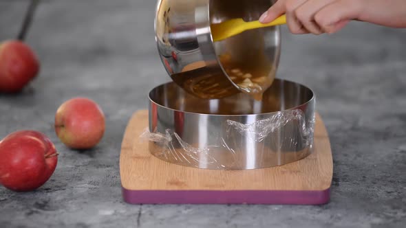 A Pastry Chef Pours the Apple Cake Filling Into a Pastry Ring