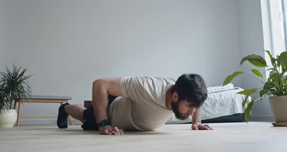 Bearded Guy Doing Push Ups in Bedroom at Home alt