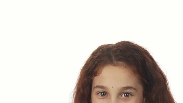 A Close-up Shows the Top Part of the Girl's Face and the Way She Picks Up the Gift alt