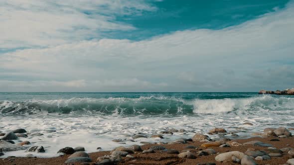 Big Waves Are Crashing on Stones and Spraying in Slow Motion. Beautiful Beach in Crimea with Stones alt