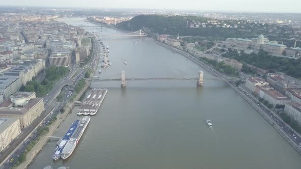 Aerial view bridges over Danube river near Parliament Budapest city, Hungary. Ships moored riverside