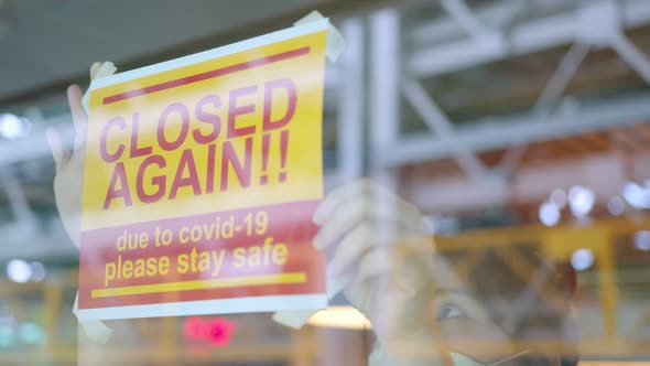 business owner stressful hand handing shop close again from spread of covid-19 alt