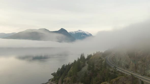 Aerial panoramic view of Sea to Sky Highway near Horseshoe Bay during a sunny winter evening before alt