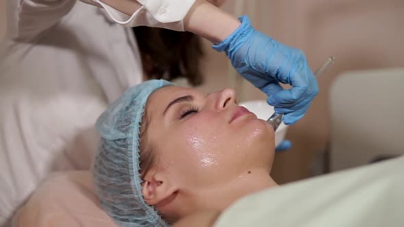 Woman in a Spa Getting Facial Mask alt