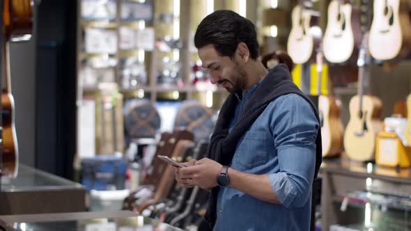 Young handsome man using smartphone and payment by smartphone contactless alt