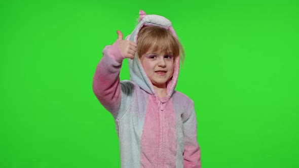 Little Child Girl Smiling Showing Thumbs Up Gesture Agree Sign in Unicorn Pajamas on Chroma Key alt