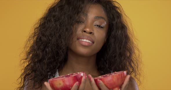 Pleased Black Woman with Pomegranate