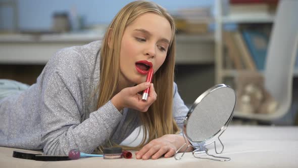 Young Lady Winking at Mirror, Flirting Practice, Wants to Attract Men Attention alt