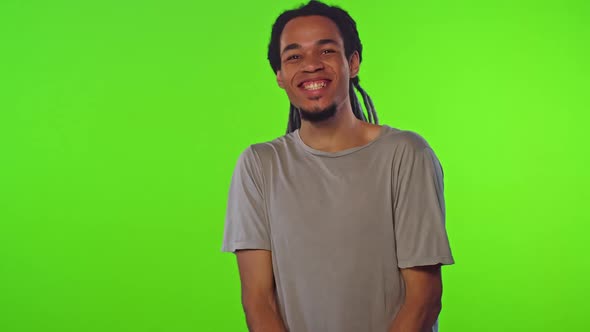 Young Overjoyed African American Man Looks at Camera and Smiles Stands in Studio alt