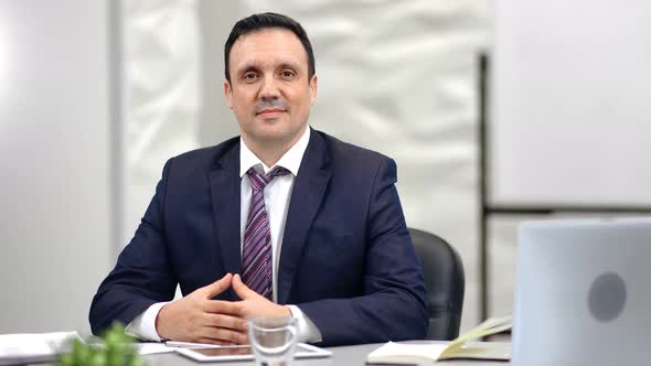 Portrait of Smiling Male Boss in Suit Posing at Workplace Looking at Camera alt