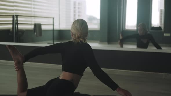 Flexible Female in Sportswear on Mat Practicing Yoga in Studio