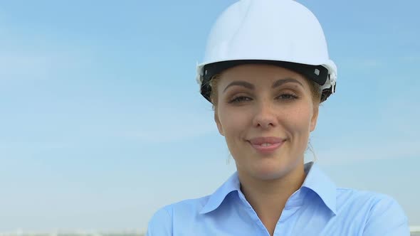 Experienced Female Architect in Safety Helmet Smiling on Camera, Good Service