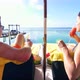 A couple relaxes and has drinks on an overwater bungalow at a tropical island resort hotel - VideoHive Item for Sale