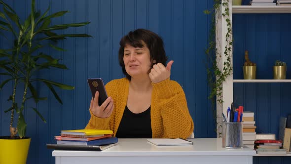 Middle Aged Woman Talking on Video Call Using Mobile Phone at Home