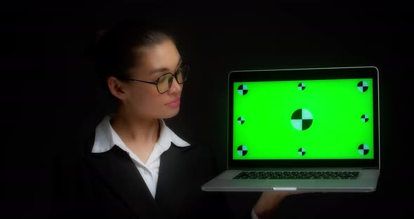Business Woman Shows a Green Laptop Screen with Tracking Markers