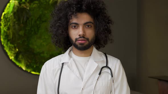 Egyptian Doctor with Stethoscope on Neck Looks in Camera alt